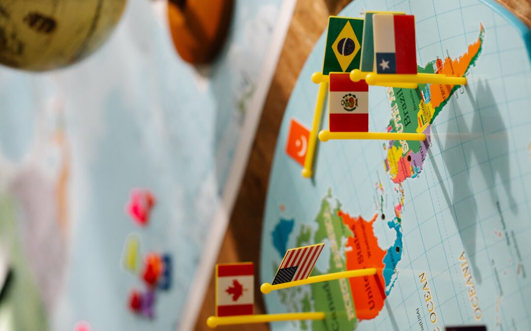 Close-up of North, Central, and South American map with small flags and a globe, highlighting geography and international relations.